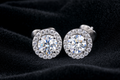 Moissanite Halo Stud Earrings on black velvet