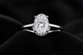 Oval Moissanite Hidden Halo Ring on black velvet